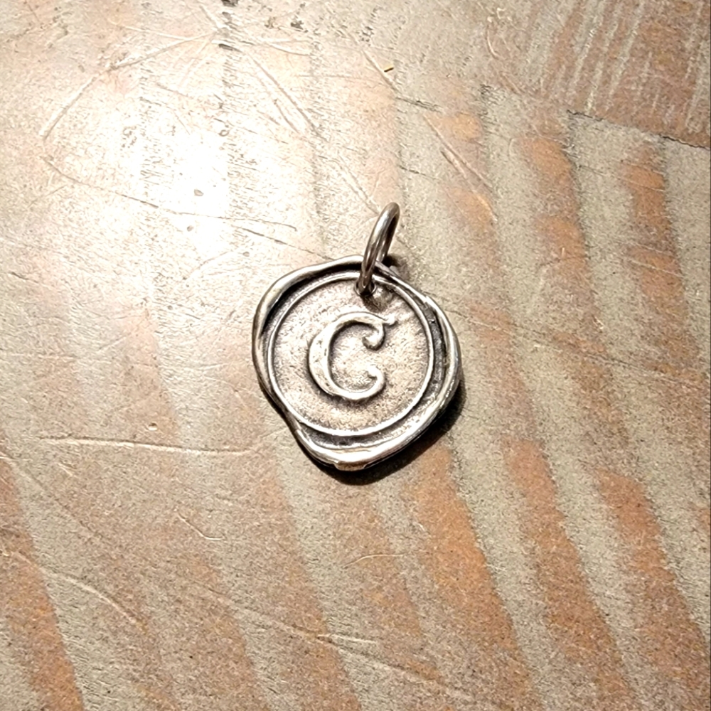 Waxing Poetic 3/4" C initial silver charm. Like new in great condition.